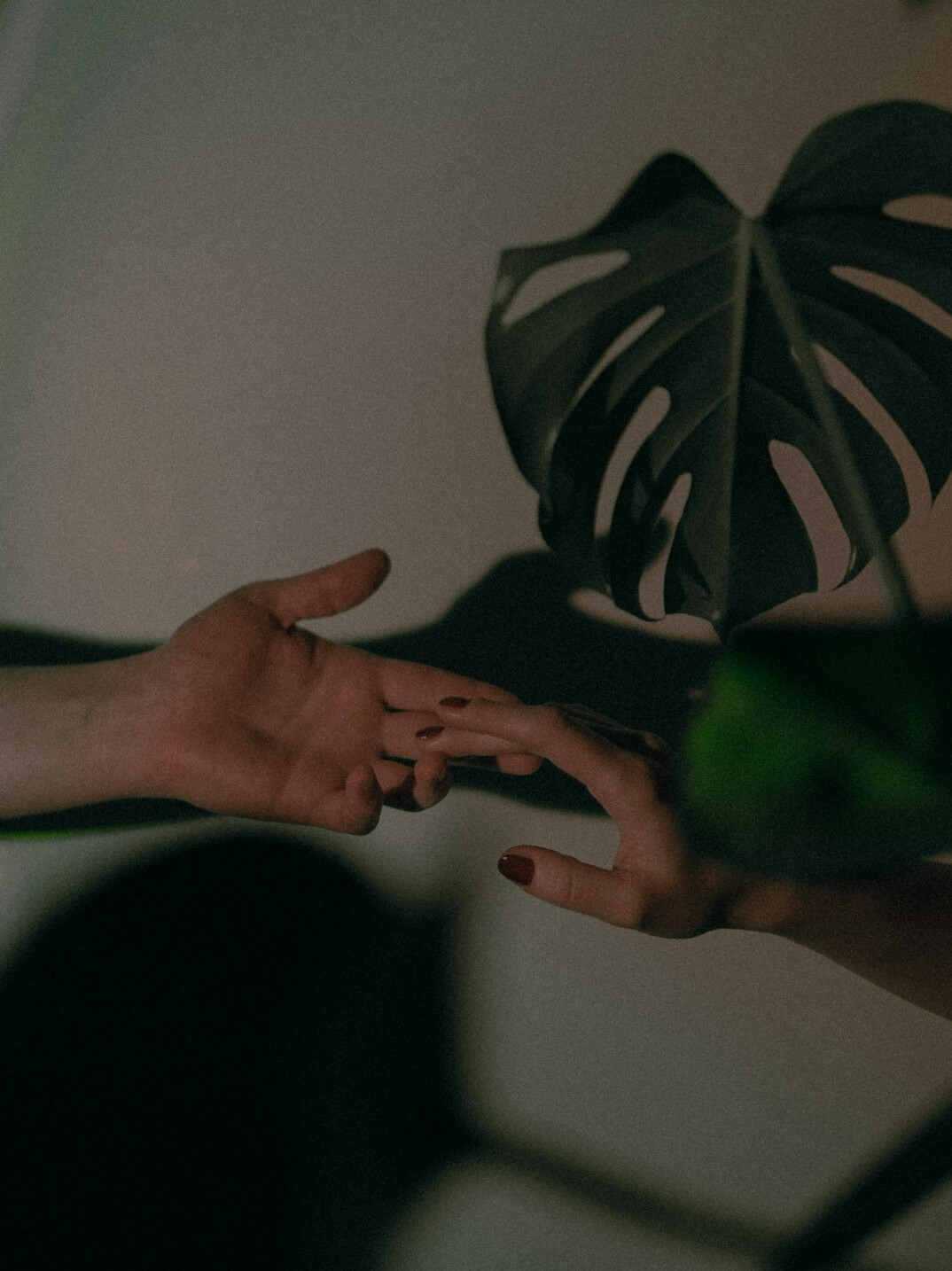 Two people shaking hands over a desk with documents