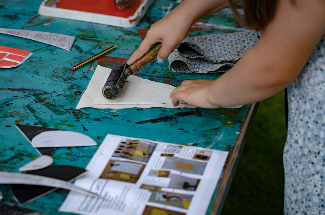 Graphic designer reviewing vintage advertising layouts at a studio desk