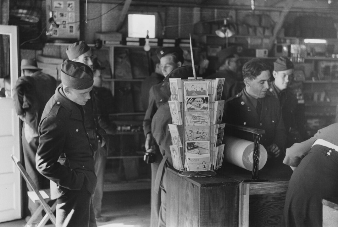 Small editorial team reviewing archive material around a table